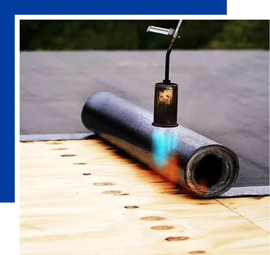 Bitumen roofing. A with a gas burner and a roll of tar paper. Flat roof installation.
