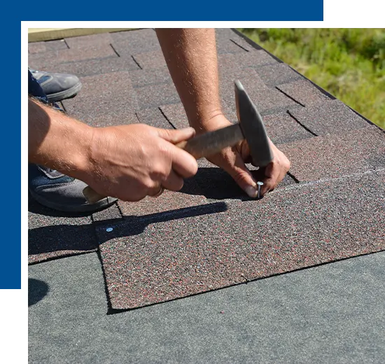 Roofer installing Asphalt Shingles on house construction roof corner with hammer and nails. Roofing construction with Asphalt Shingles.